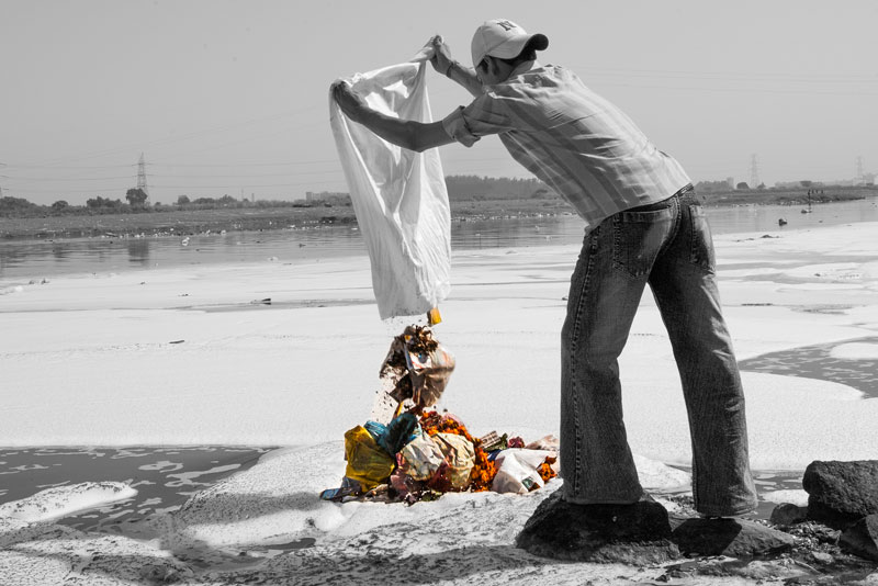 Disposing solid waste remaining from religious rituals in sacred river Yamuna in South-East district, National Capital Territory of Delhi